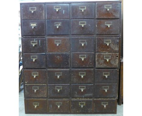 An early 20th Century mahogany and oak twenty eight drawer chemists shop cabinet