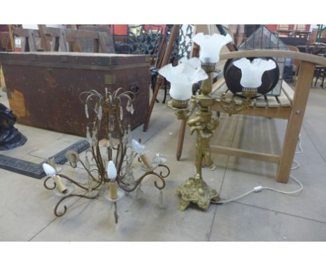 A gilt metal cherub table lamp and a chandelier