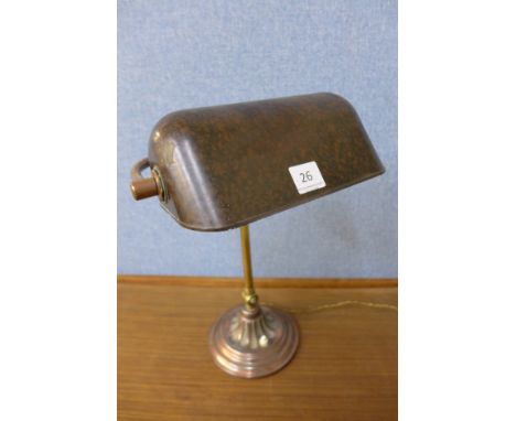 A copper effect anglepoise desk lamp