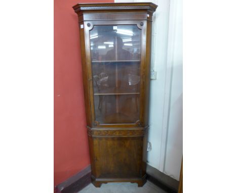 A mahogany freestanding corner cabinet