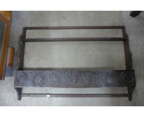 A carved oak wall shelf