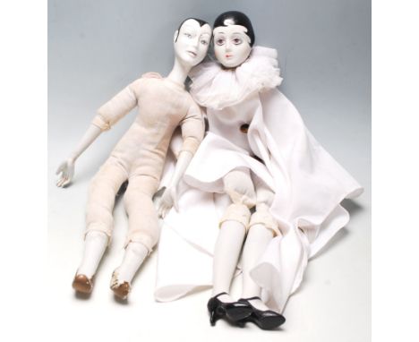 Two vintage porcelain French Pierrot dolls, having porcelain head, hands, and legs having hand-painted faces, nails and shoes
