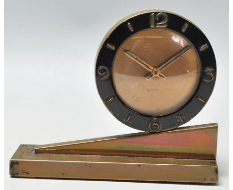 A 1920's Art Deco 8 days mantel clock having a round case with black enamelled case with arabic numerals to the chapter ring,