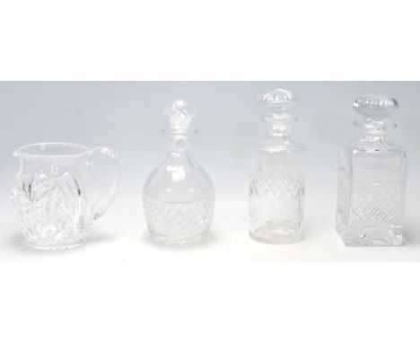 A group of 20th Century cut glass decanters to include a whiskey decanter, bottle decanter, and sherry decanter all complete 
