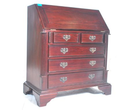 A 20th Century Georgian revival mahogany bureau with drop front and appointed sectional interior over five graduated drawers 