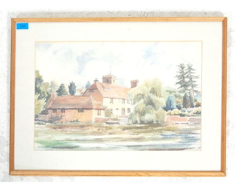 A mid 20th century watercolour painting depicting a cottage next to a lake with trees and boat. Illegible signature to the lo