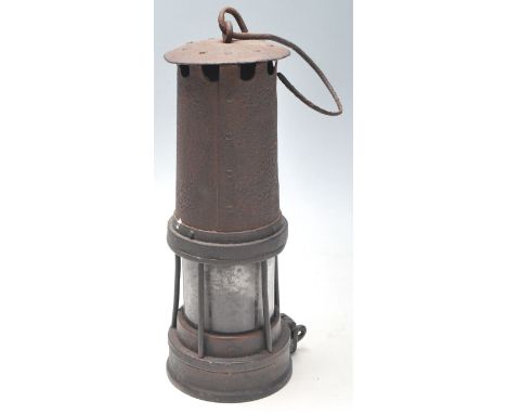 A 19th century Victorian miners lamp with hook swing handle, brass and metal body united by rivets with glass shade. Measures