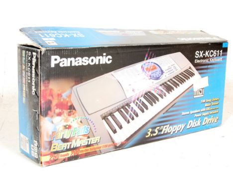 A retro vintage Casio Panasonic SX - KC611 61 key touch sensitive electronic synthesiser keyboard / piano featuring a music t