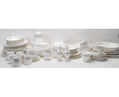 A large vintage fine bone china dinner service by Mayfair comprising of tea cups, coffee cups, dining plates, gravy boat, sal