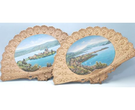 Two 20th Century ceramic wall mounting fans / chargers each having moulded raised decoration with Swiss landscape scene panel