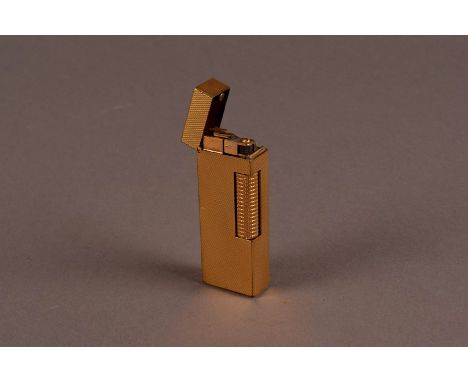 A 1960s gold plated Dunhill cigarette lighter, the rectangular pocket lighter with hinged cover and engine turned exterior