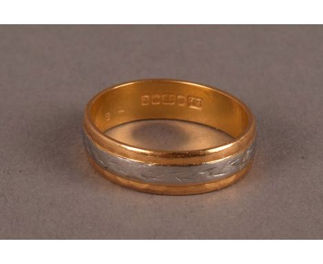 A 22ct gold and platinum wedding band, hallmarked, having inset central band of engraved platinum, approx. 3.6g and size M