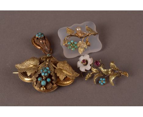 Three Victorian and later brooches, one a hardstone plaque with gold flower having pearl and turquoise beads, another as a fl