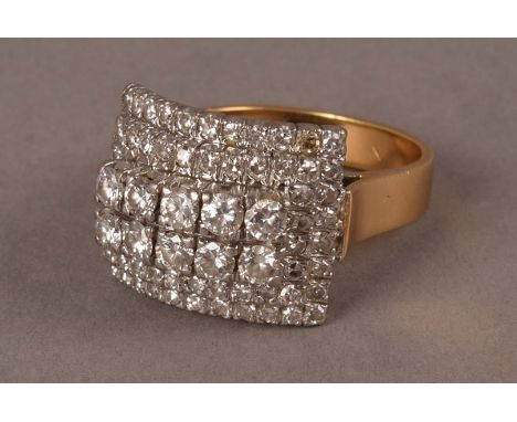 A large diamond cluster dress ring, the rectangular tablet centred by two rows of five brilliant cuts and surrounded by two r