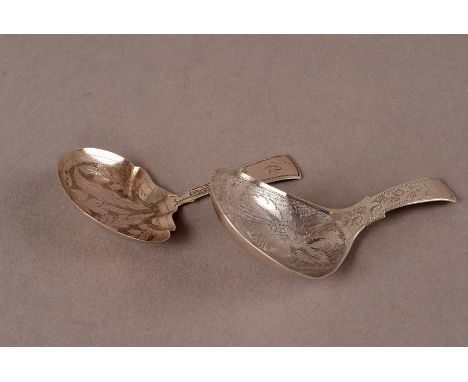 Two Georgian silver tea caddy spoons, both with engraved designs, one by L & Co and the other by JC, both c.1800 (2)