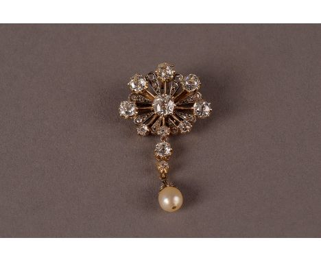 A fine Edwardian period diamond brooch cum pendant with diamond and pearl drop, the upper gold flower head mount centred with