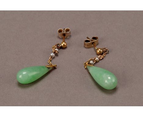 A pretty pair of Chinese hardstone pendant earrings, the pear shaped jade style drop supported in links set with two seed pea