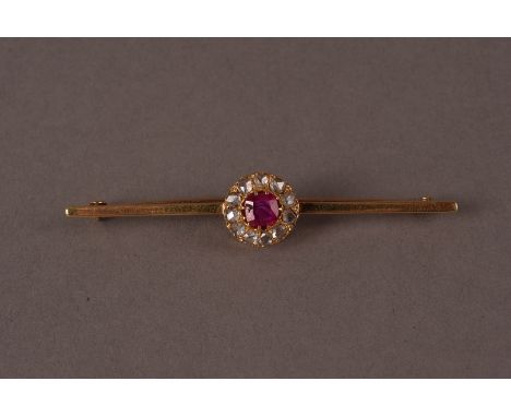 A vintage 15ct ruby and diamond bar brooch, having a cluster to the centre with a square cut red stone surrounded by rose cut