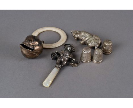 A group of three Victorian and later rattles and thimbles, one teddy baby rattle in the form of a teddy bear with MOP handle,