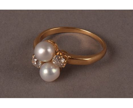 A pearl and diamond crossover style ring, set in gold, probably 18ct, having two white pearls and two old cuts, approx. 2.6g 