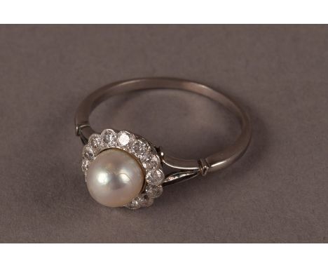 A vintage pearl and diamond cluster ring, the white metal tablet centred by a white pearl and surrounded by old cuts, with sp