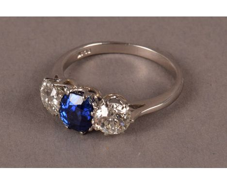 A certified platinum diamond and sapphire three stone engagement ring, having a central blue natural sapphire with certificat