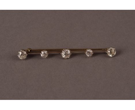 A vintage five stone bar brooch, the gold and platinum bar having crown claw set old cuts stones of varying sizes, approx. 4.