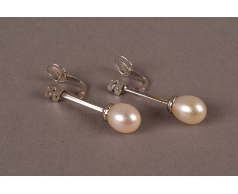 A pair of modern white metal and pearl drop pendant earrings, marked 750, with white pearl to lower and clear stone to post, 