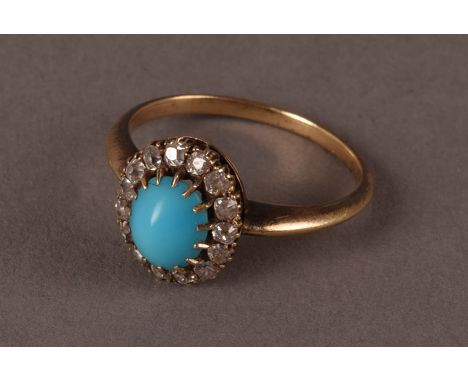 A vintage turquoise and diamond cluster dress ring, the oval polished light blue bead surrounded by old cuts on a yellow meta