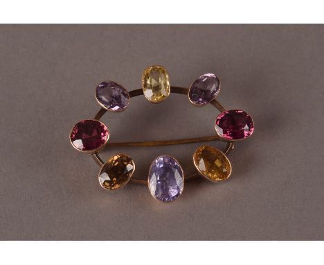 A vintage gem set brooch, oval frame mounted with oval cut stones in collect settings, approx. 9g and 4.2cm wide
