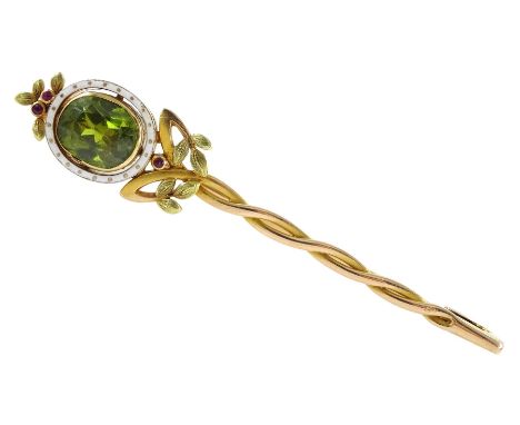 Early 20th century 14ct gold German peridot brooch, oval peridot of approx 9mm x 8mm, depth approx 4.5mm, with white enamel s