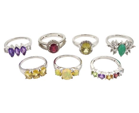 Seven silver stone set rings including emerald and topaz, amethyst, opal, ruby and white topaz, citrine and quartz, all stamp