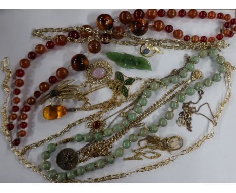 A collection of costume jewellery, to include an amber pendant, a green enamel shamrock brooch, a silver gilt 'scorpio pendan