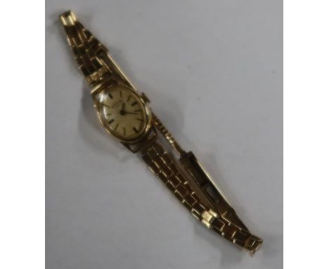 A lady's Rotary 9ct gold cased wristwatch, the oval dial with baton numerals on 9ct bracelet, weight 16g