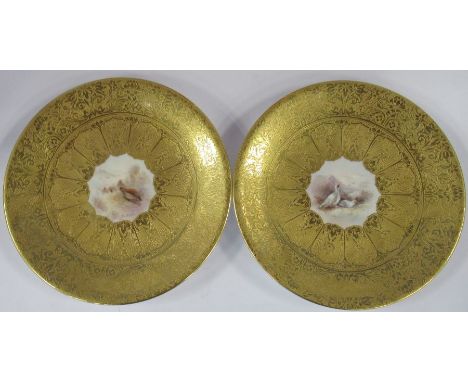 A pair of Royal Worcester dishes, the gilded dishes painted to the centers with partridge and ptarmigan in a landscape by Jas