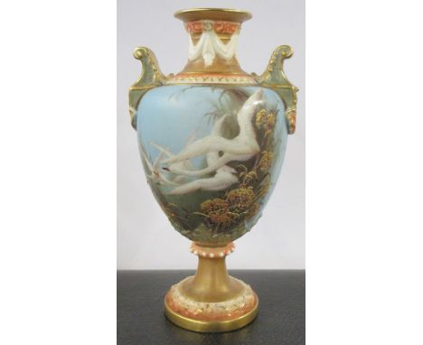 A Royal Worcester pedestal vase, the front decorated with swans in flight by C H C Baldwyn, the back with a swallow, to a pow