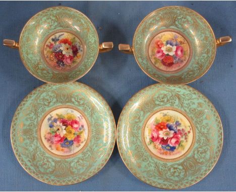 A pair of Royal Worcester twin handled bowls and saucers, decorated with flowers by E Philips, to a green and gilt border -&n