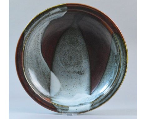 RAY FINCH (1914-2012) for Winchcombe Pottery; a shallow stoneware dish covered in iron rich and mottled grey glaze, impressed