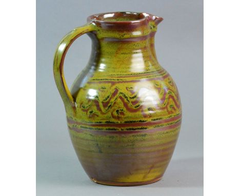 RAY FINCH (1914-2012) for Winchcombe Pottery; a stoneware jug covered in kaki glaze, black with lime speckles and meander pat