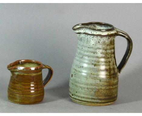 Leach Pottery; two stoneware jugs covered in mottled grey and brown glaze, impressed pottery marks, tallest height 19cm (2). 