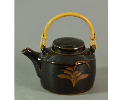 DAVID LEACH (1911-2005) for Lowerdown Pottery; a stoneware teapot with cane handle, tenmoku glaze with kaki foxglove decorati