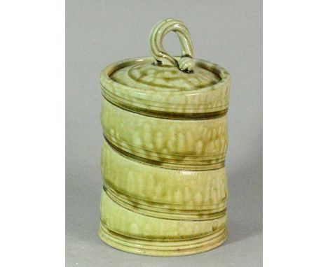 WALTER KEELER (born 1942); a stoneware jar with finial cover, incised spiral decoration covered in mottled green ash glaze, i