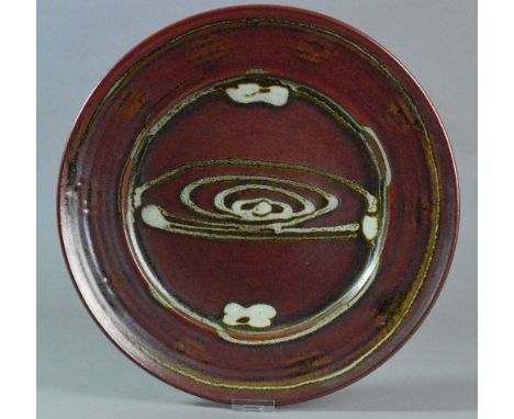 RAY FINCH (1914-2012) for Winchcombe Pottery; a large stoneware charger covered in iron rich glaze with mottled grey decorati