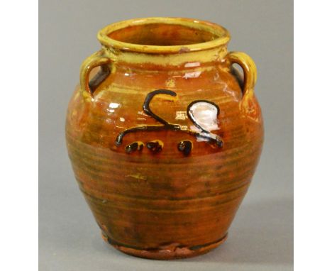 Winchcombe Pottery: an early slipware vase with three lug handles covered in a rich treacle yellow glaze, impressed pottery m