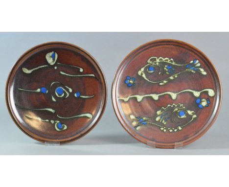 RAY FINCH (1914-2012) for Winchcombe Pottery; two large stoneware plates covered in iron rich glaze, one with fish decoration
