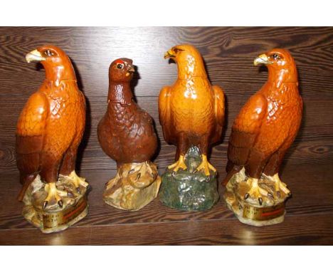 TWO BESWCK GOLDEN EAGLE DECANTERS 
together with a Royal Doulton golden eagle decanter and a Royal doulton Grouse decanter