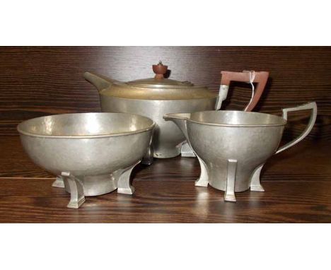 ART DECO BEATEN PEWTER THREE-PIECE TEA SERVICE
maker James Dixon & Sons, comprising a teapot, sugar and cream, each of stylis