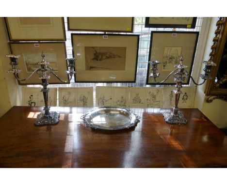 A pair of electroplated twin branch candelabra,&nbsp;40cm high; together with another electroplated oval stand, 36cm wide. 
