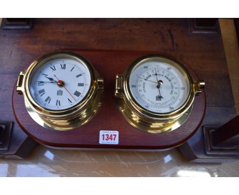 A combined brass clock and barometer set, by Sewills, the whole 35cm wide.&nbsp;&nbsp; 