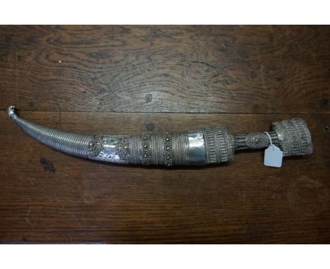 A 19th century Ottoman silver mounted jambiya and associated scabbard, 24cm blade. 